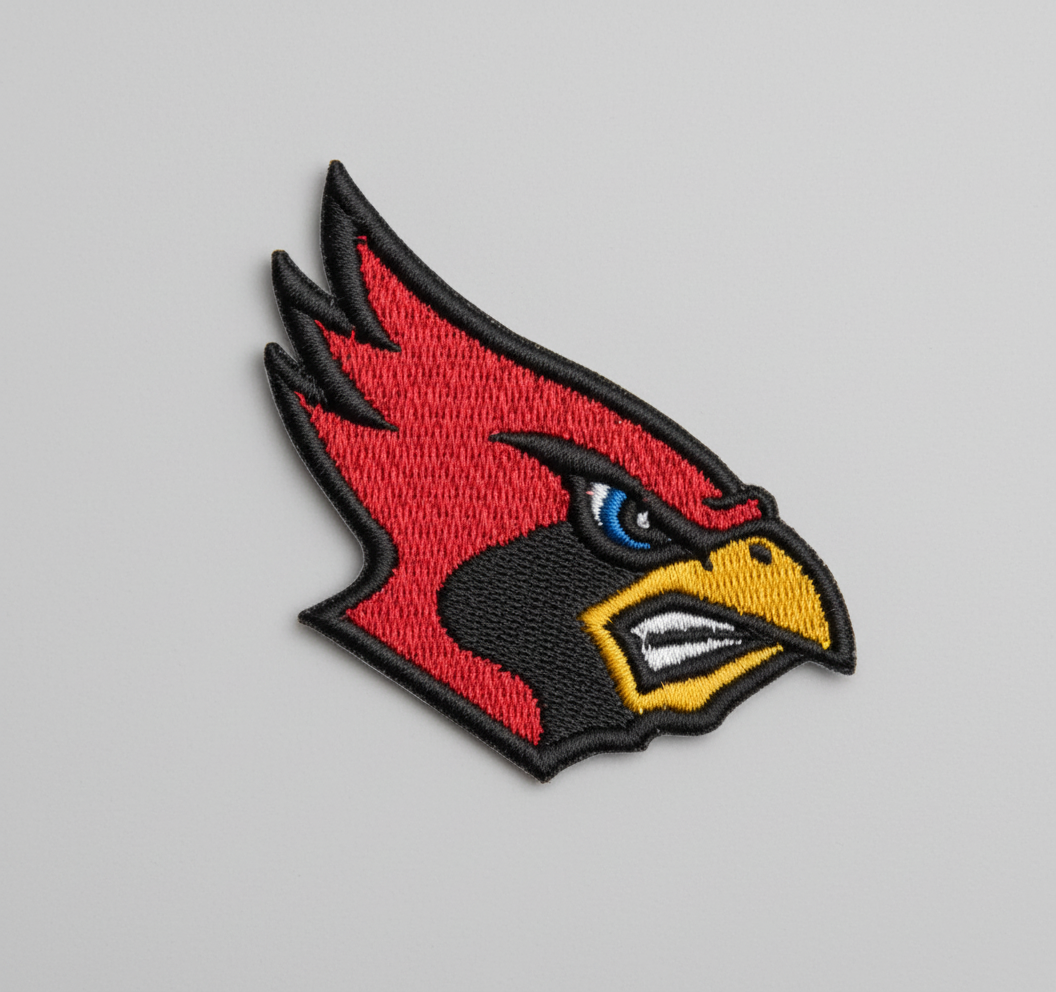 Embroidered patch of a cardinal bird head on a grid background