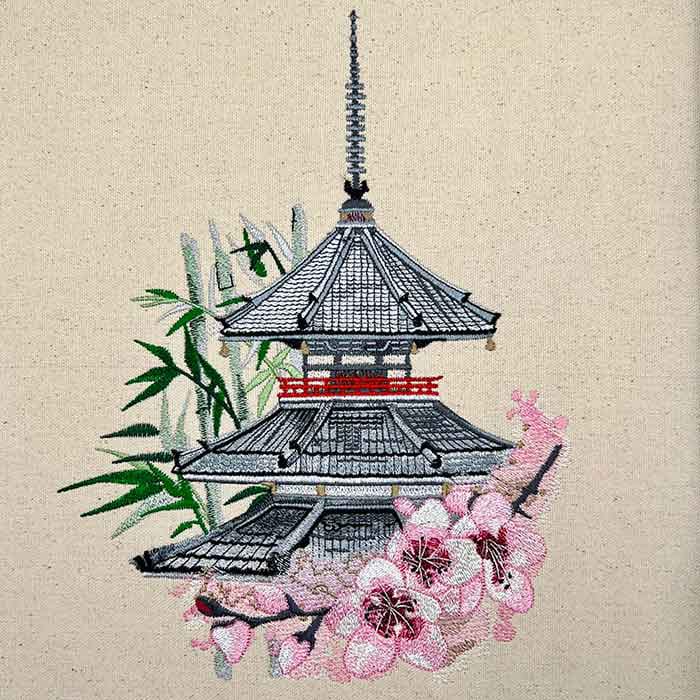Embroidered design of a pagoda with cherry blossoms and bamboo on a beige background