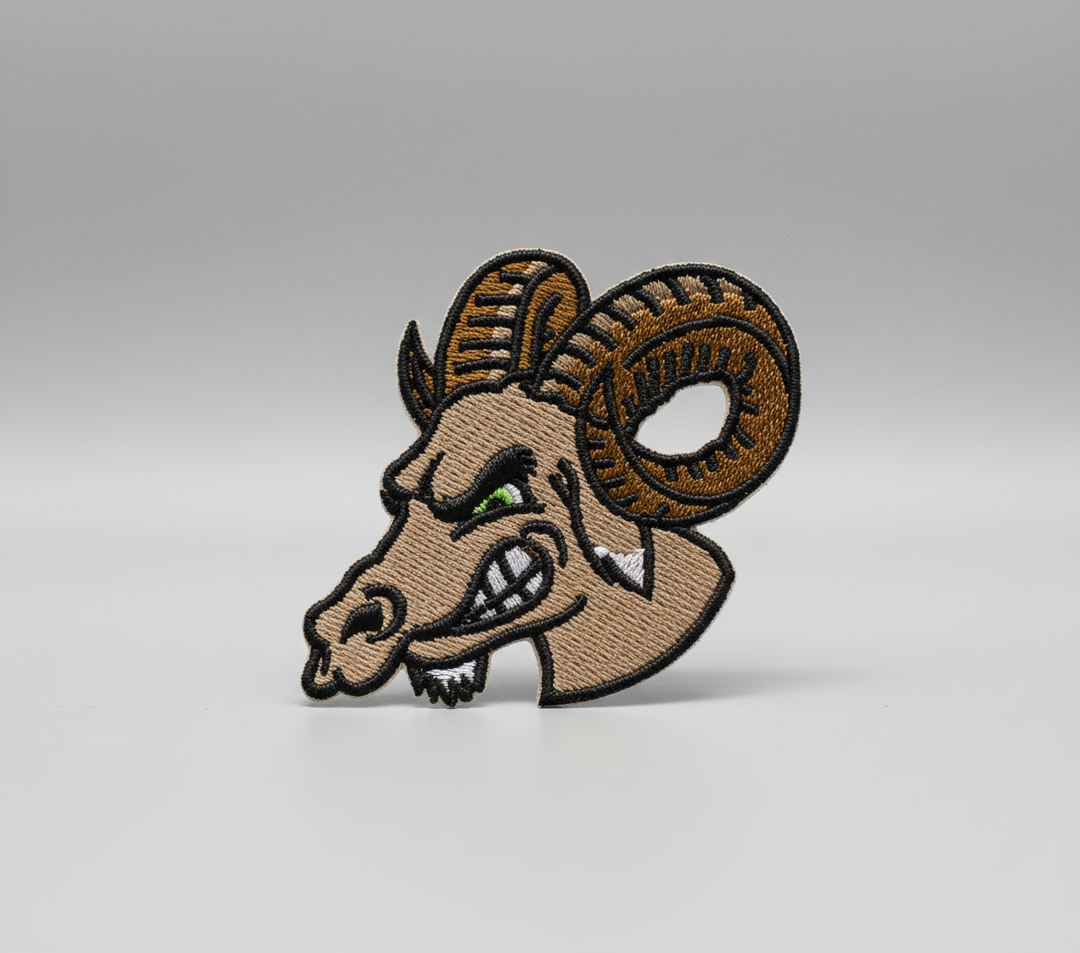Embroidered design of a ram's head on a grid background