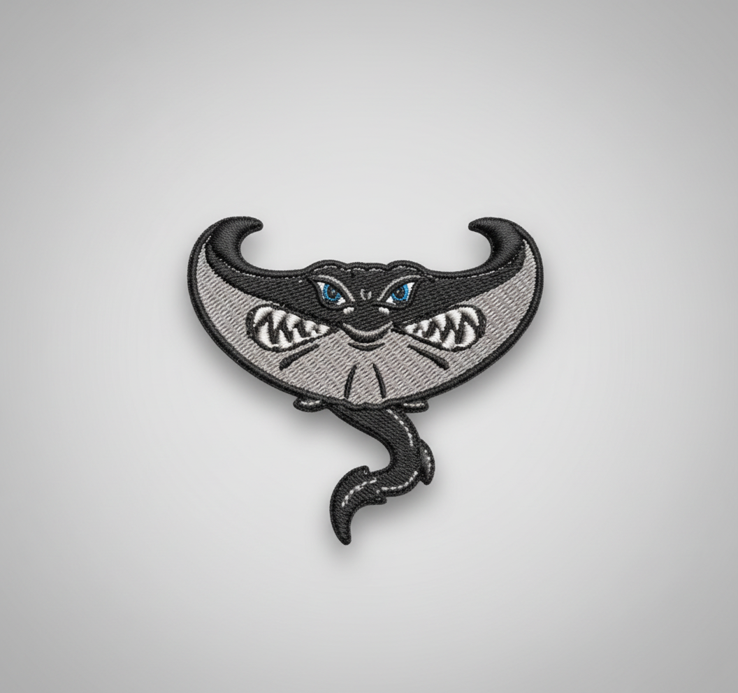 Embroidered design of a stingray on a grid background