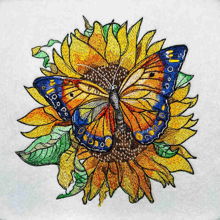 Butterfly on a sunflower with embroidered details on white fabric