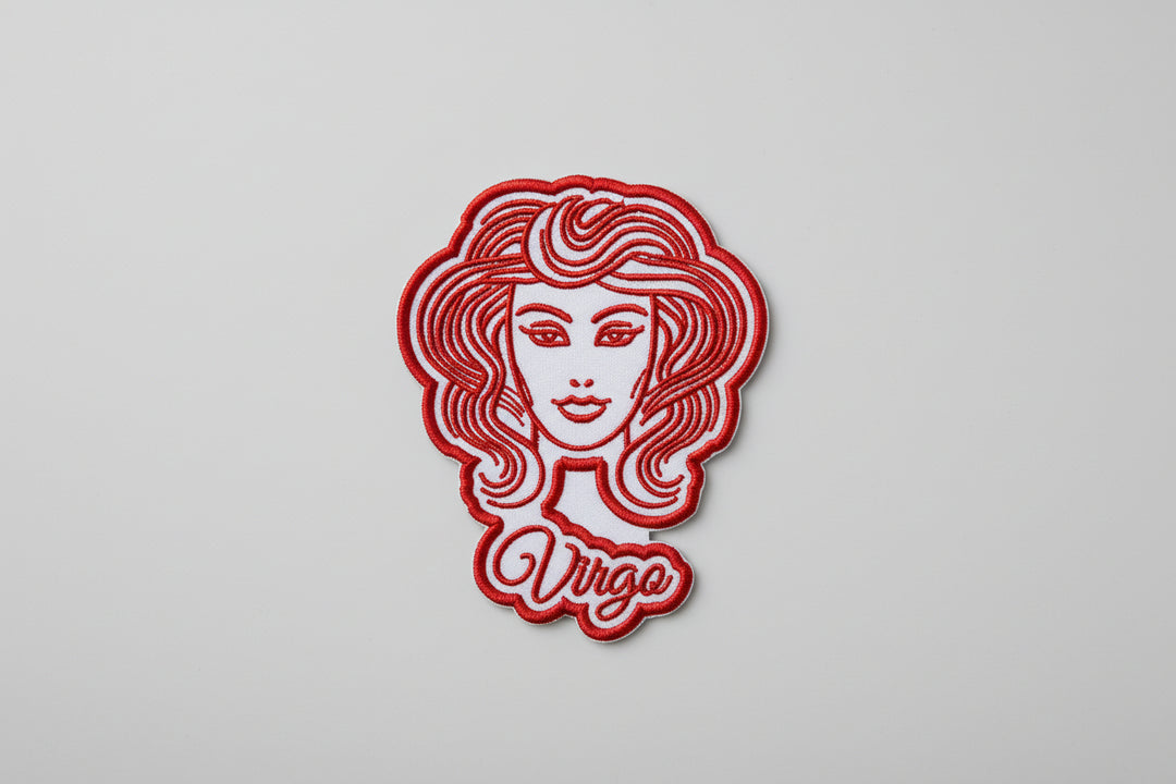 Red Virgo maiden face zodiac embroidered patch with flowing hair and “Virgo” script text on a white grid background.
