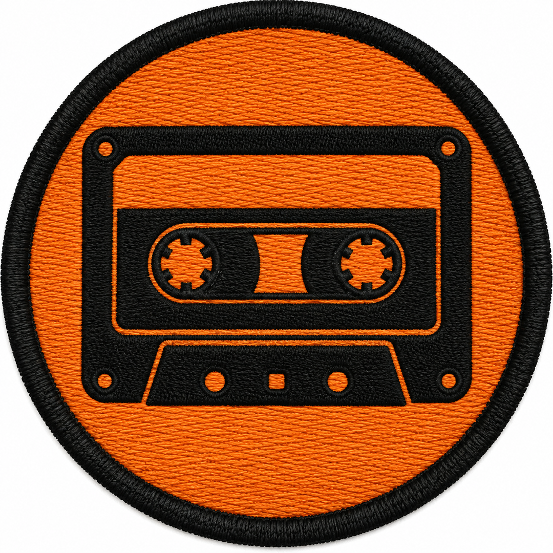 Cassette Classic embroidery patch featuring a cassette tape silhouette with reel details in flat black and orange | Hand Finished in Dubai | EmbroMania