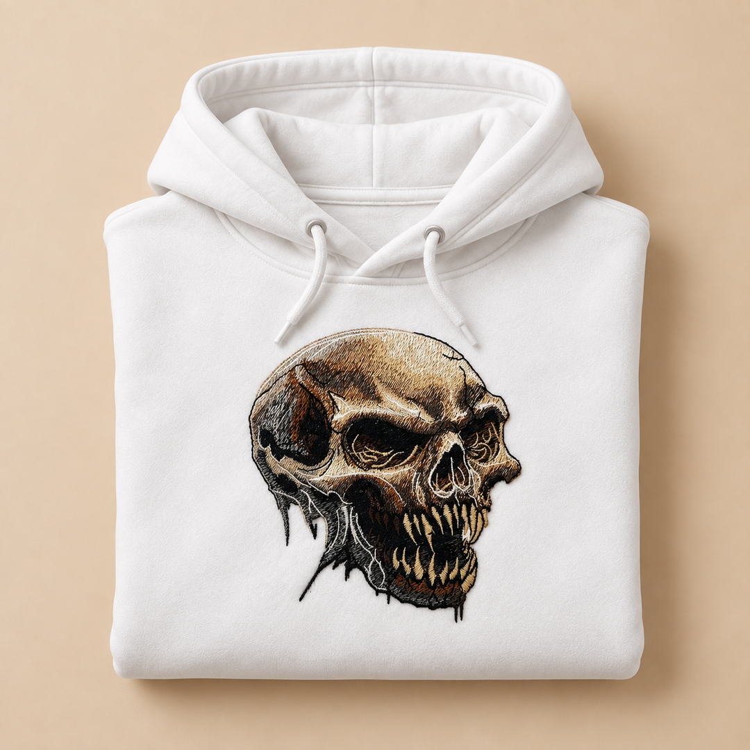 Feral Bonefang Skull Machine Embroidered Hoodie in Medium Black – Bone-toned fanged skull design embroidered on black 320gsm premium fleece | Hand Finished in Dubai