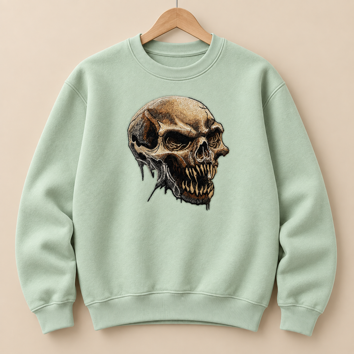 Feral Bonefang Skull Machine Embroidered Sweatshirt in Medium Khaki – Bone-toned fanged skull design embroidered on khaki 320gsm cotton fleece crewneck | Hand Finished in Dubai