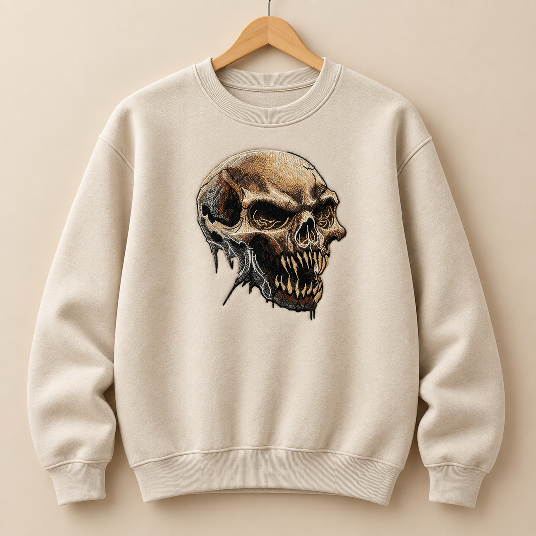 Feral Bonefang Skull Machine Embroidered Sweatshirt in Medium White – Bone-toned fanged skull design embroidered on white 320gsm cotton fleece crewneck | Hand Finished in Dubai