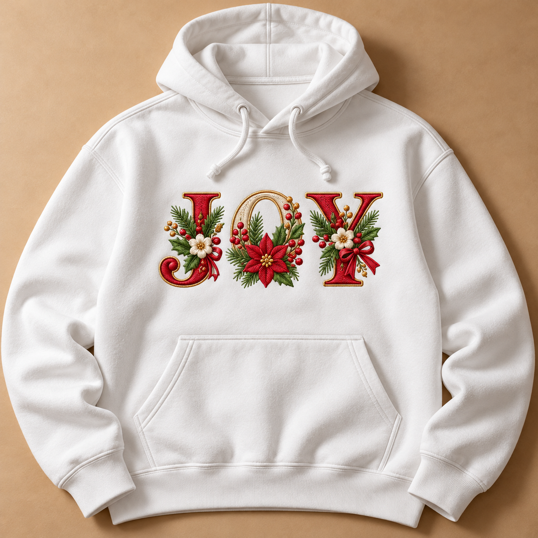 Festive Poinsettia Alphabet custom lettering "JOY" machine embroidered on a white hoodie – red and cream serif letters with gold outline, poinsettias, holly and berries | Hand Finished in Dubai | EmbroMania