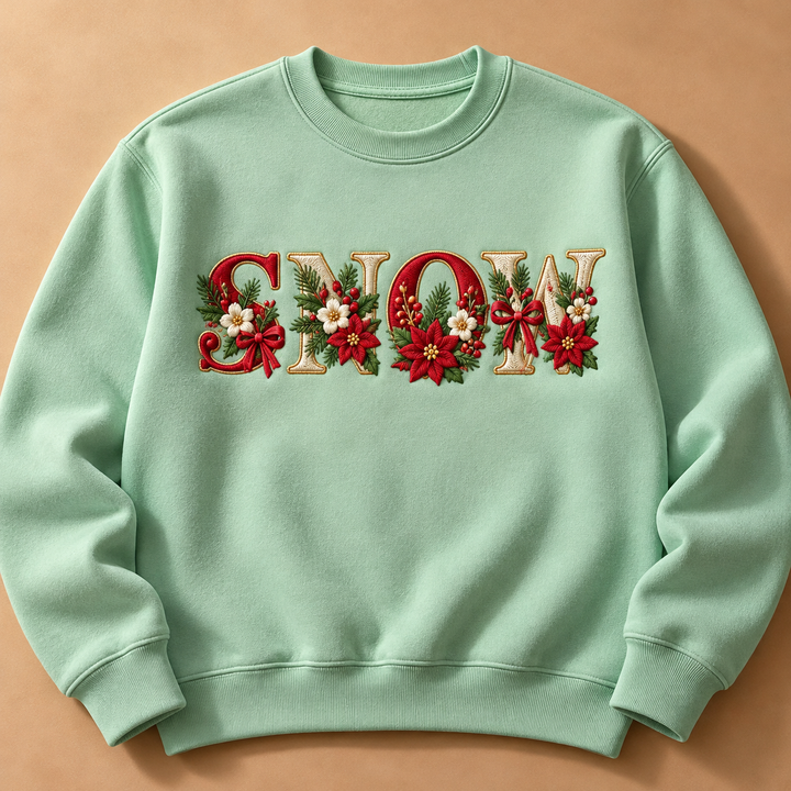 Festive Poinsettia Alphabet custom lettering "SNOW" machine embroidered on a mint green sweatshirt – red and cream serif letters with gold outline, poinsettias, holly and berries | Hand Finished in Dubai | EmbroMania
