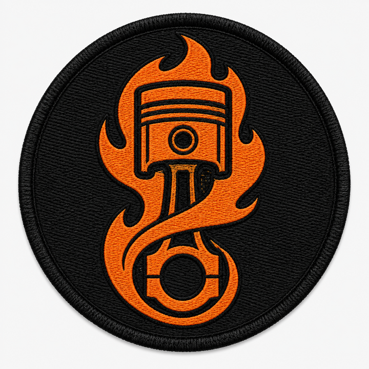 Flame Piston embroidery patch featuring an engine piston wrapped in flame in flat orange and black | Hand Finished in Dubai | EmbroMania