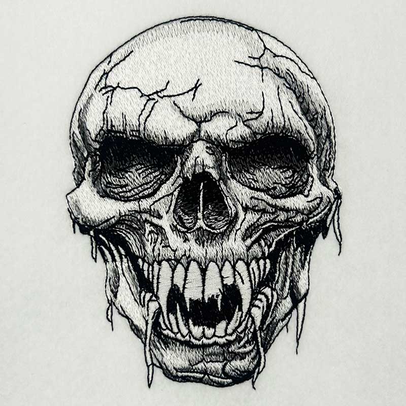 Hollow Fang Skull Machine Embroidered Sweatshirt – Close-up detail of monochrome fanged skull embroidery with fine crack and stitch texture | Hand Finished in Dubai