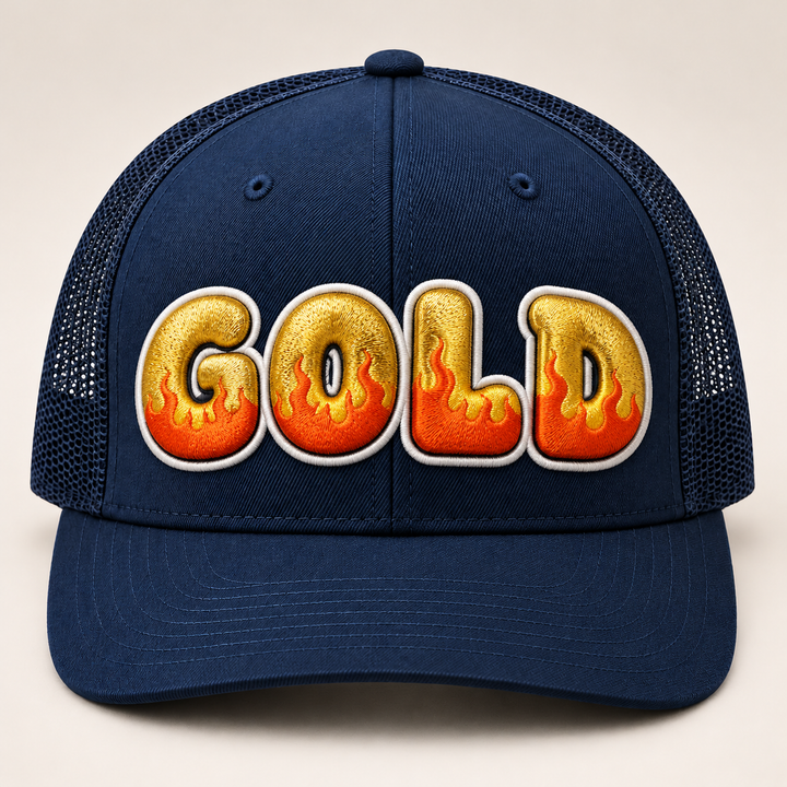 🔥👑 Gilded Flame – Inferno Pop Custom Cap Font · Gold fill · Orange flame · White outline · Dark Navy Curved Trucker | Hand Finished in Dubai | EmbroMania