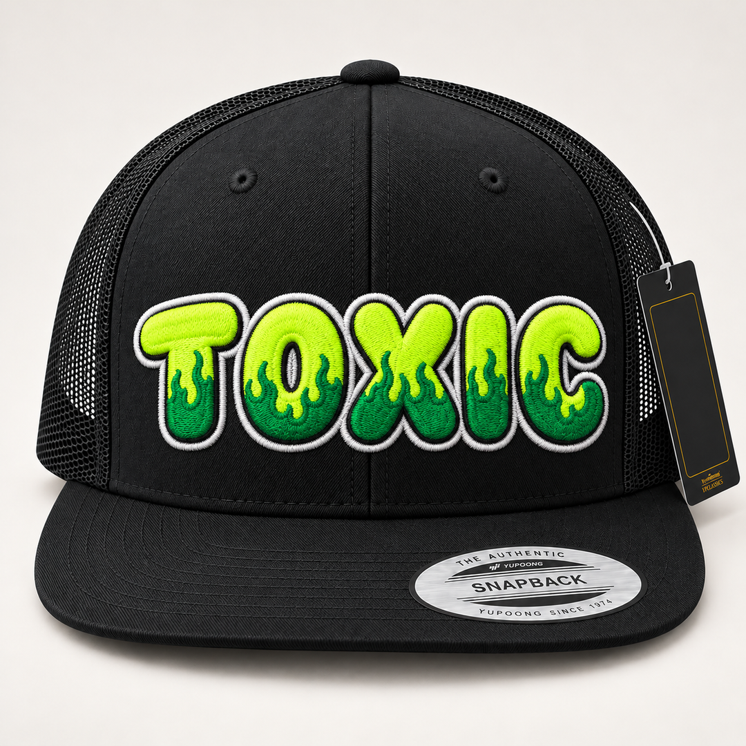 🔥💚 Toxic Blaze – Inferno Pop Custom Cap Font · Neon lime fill · Emerald flame · White outline · Black Flat Trucker | Hand Finished in Dubai | EmbroMania