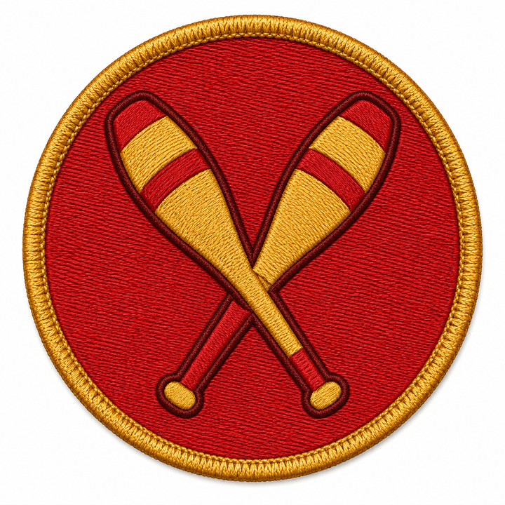 Juggling Pins Cross embroidery patch featuring two crossed juggling batons in red and gold on a red circular patch | Hand Finished in Dubai | EmbroMania