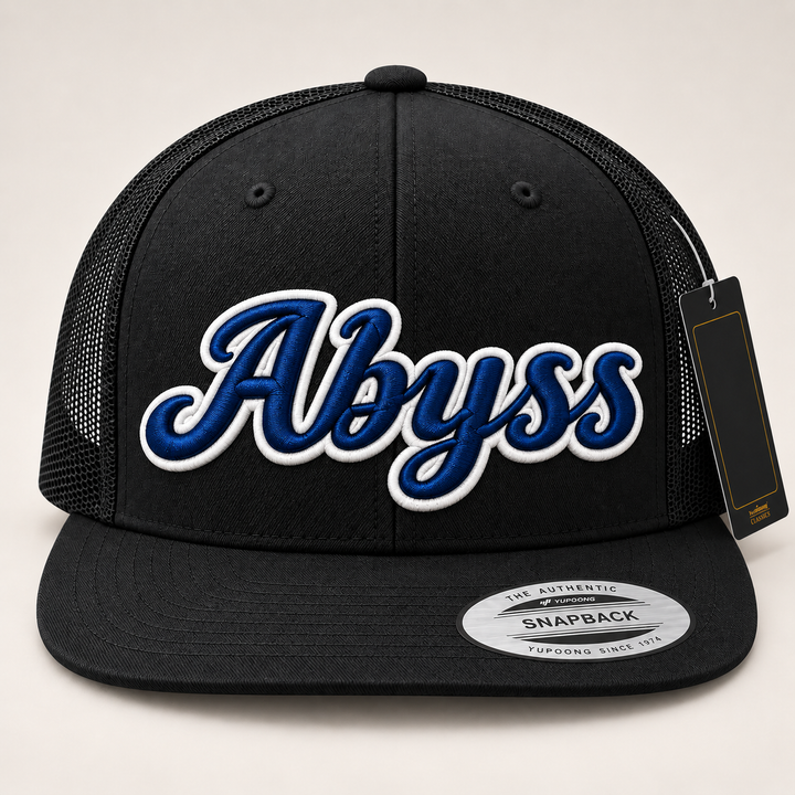 🔵⚪ Abyss Frost – Monarch Script 3D Puff · Navy fill · White outline · Black Flat Trucker | Hand Finished in Dubai | EmbroMania
