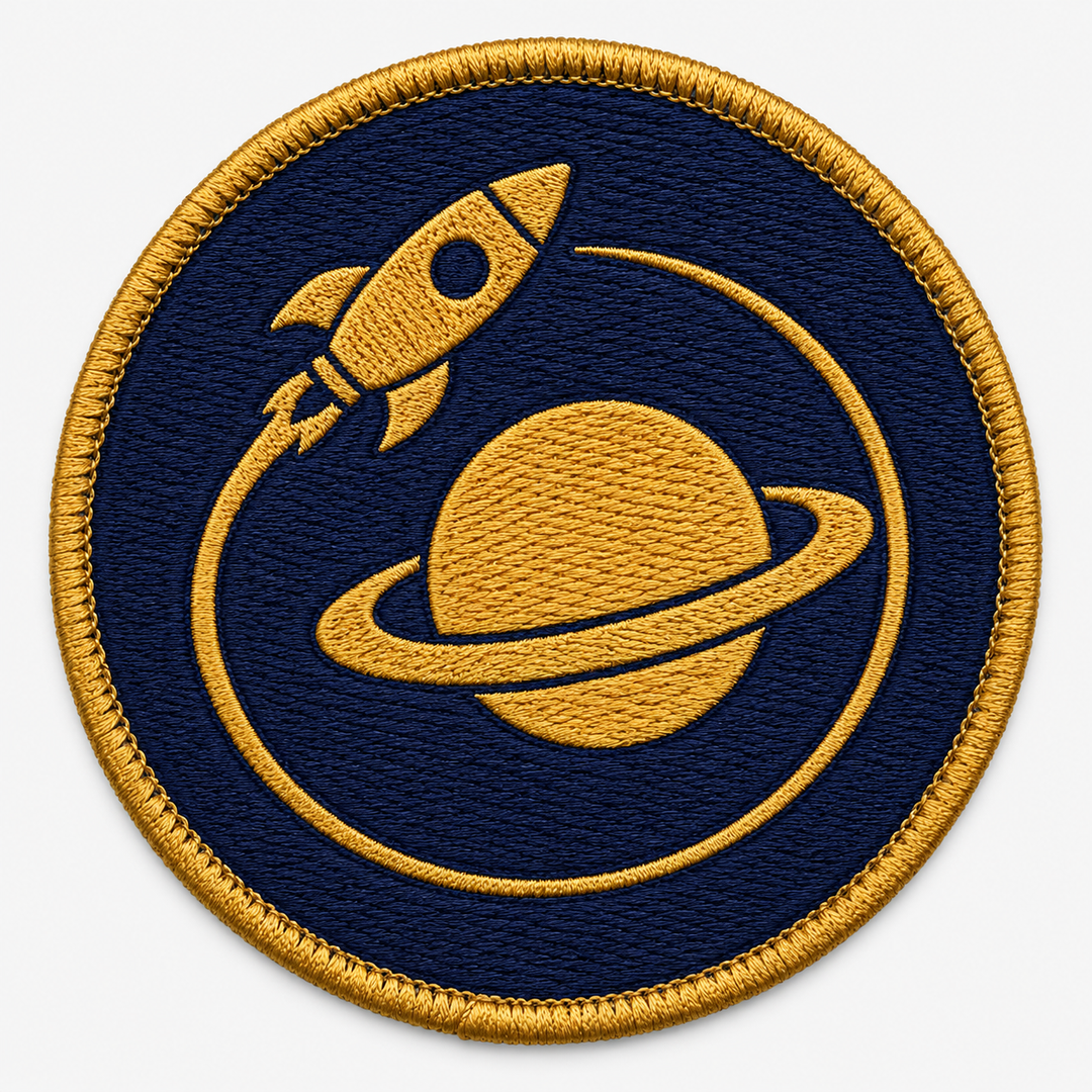 Orbit Voyager embroidery patch featuring a simple rocket circling a ringed planet in flat indigo and gold | Hand Finished in Dubai | EmbroMania