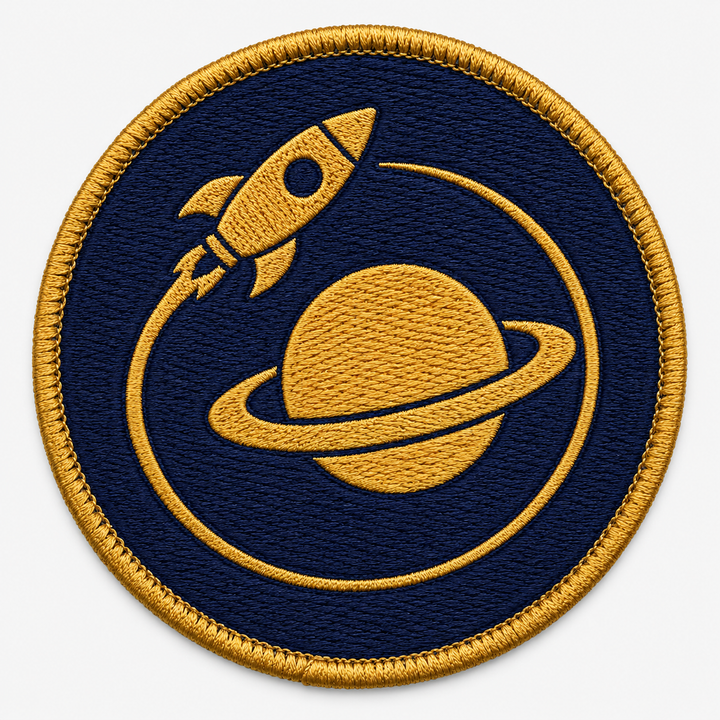 Orbit Voyager embroidery patch featuring a simple rocket circling a ringed planet in flat indigo and gold | Hand Finished in Dubai | EmbroMania