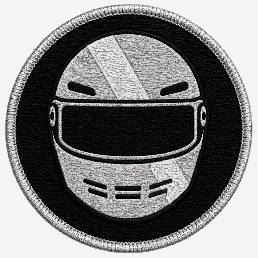 Racing Helmet Crest embroidery patch featuring a front-facing racing helmet with a diagonal stripe in flat black and silver | Hand Finished in Dubai | EmbroMania