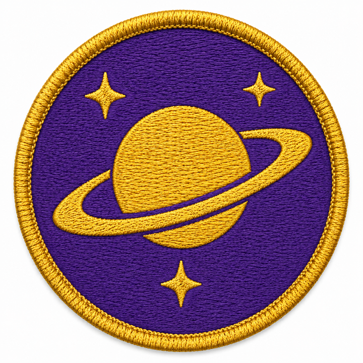Ringed Planet embroidery patch featuring a single ringed planet with stars in flat purple and gold | Hand Finished in Dubai | EmbroMania