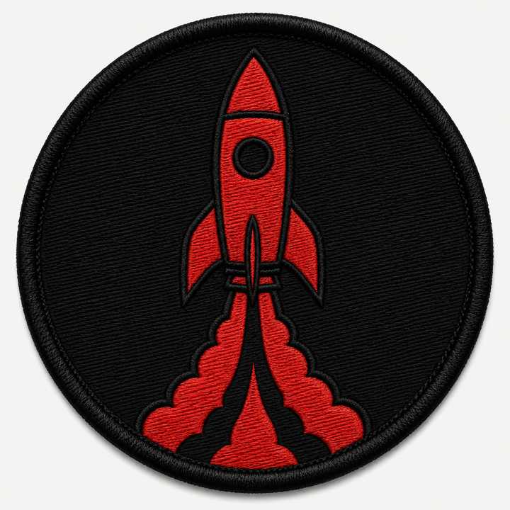 Rocket Launch embroidery patch featuring a rocket launching upward with a simple flame trail in flat red and black | Hand Finished in Dubai | EmbroMania