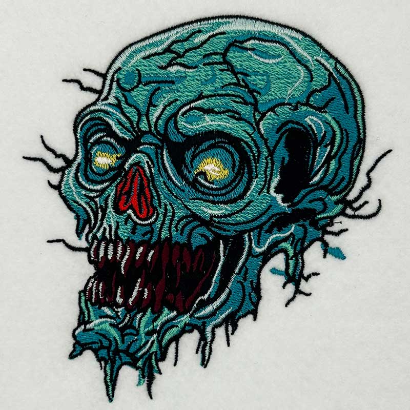 Swamp Wraith Skull Machine Embroidered Sweatshirt – Close-up detail of rotting teal skull embroidery with fine crack and tendril texture | Hand Finished in Dubai