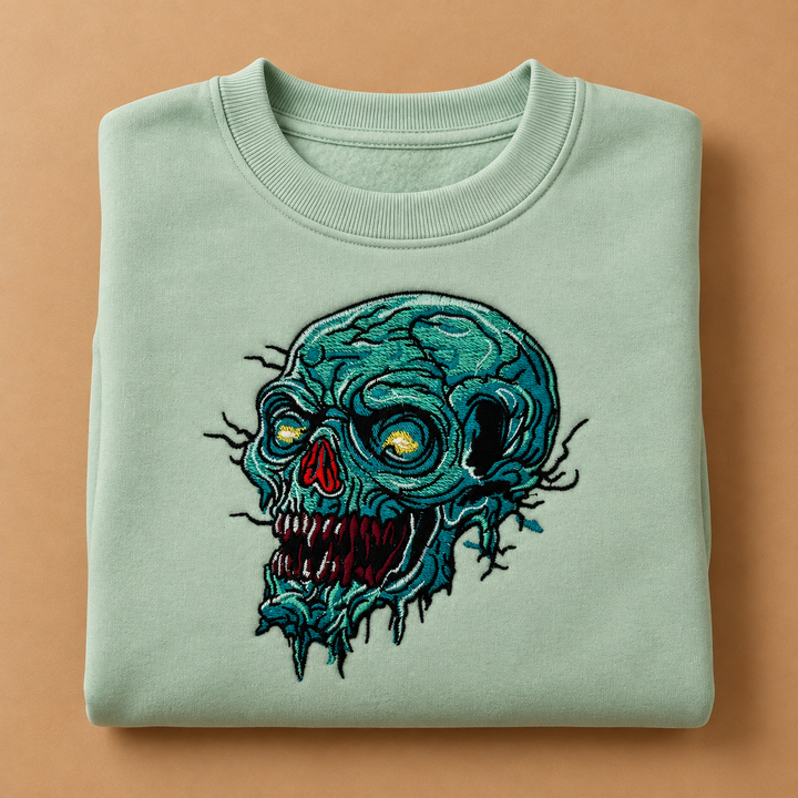 Swamp Wraith Skull Machine Embroidered Sweatshirt in Large Khaki – Rotting teal skull design embroidered on khaki 320gsm cotton fleece crewneck | Hand Finished in Dubai