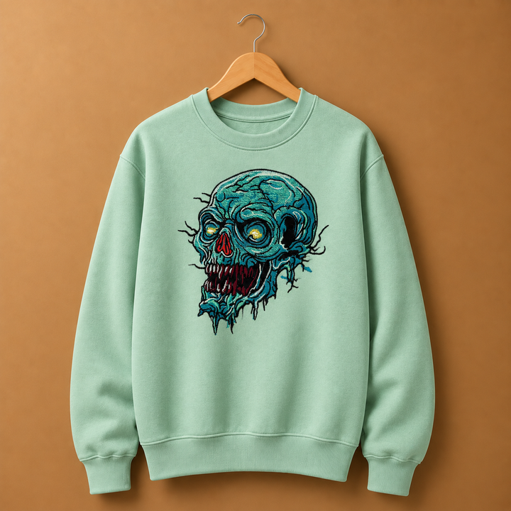 Swamp Wraith Skull Machine Embroidered Sweatshirt in Medium Khaki – Rotting teal skull design embroidered on khaki 320gsm cotton fleece crewneck | Hand Finished in Dubai