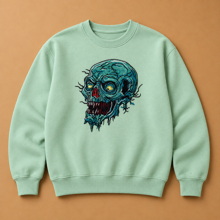 Swamp Wraith Skull Machine Embroidered Sweatshirt in Small Khaki – Rotting teal skull design embroidered on khaki 320gsm cotton fleece crewneck | Hand Finished in Dubai